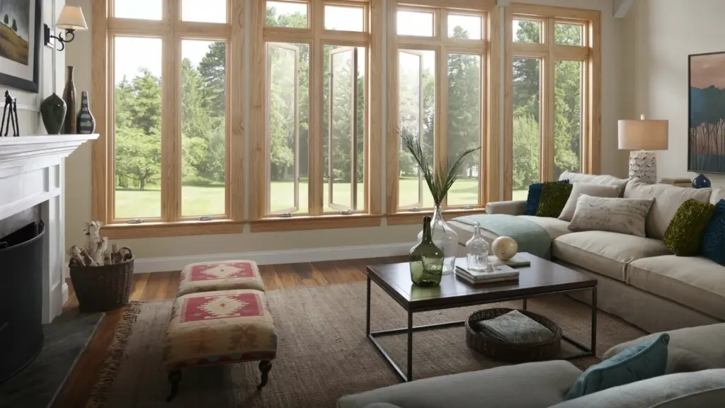 Living room with a wall of tall wood-frame windows