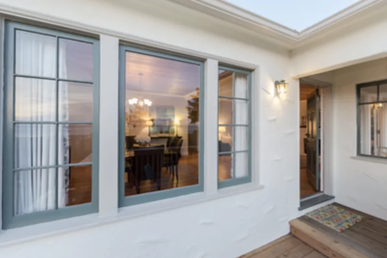 Large picture windows on a white home with gray trim